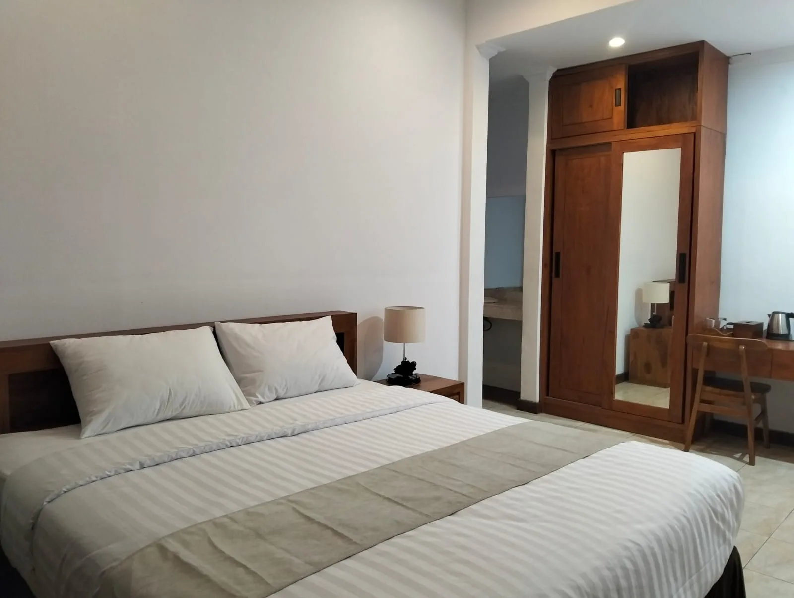 Treatment room with a bed and white curtains